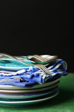 Retro tableware and napkins on old wooden table, on dark backgroundの写真素材