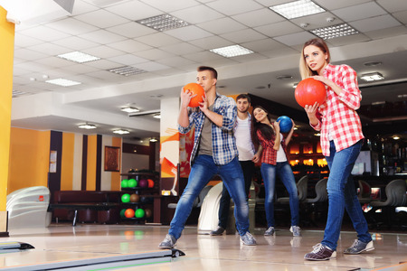 Friends playing in bowling clubの写真素材