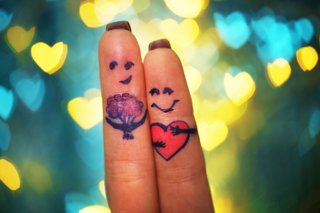 Lovers fingers on bokeh backgroundの写真素材