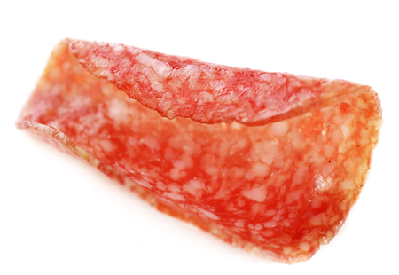 Slice of salami isolated on white backgroundの写真素材