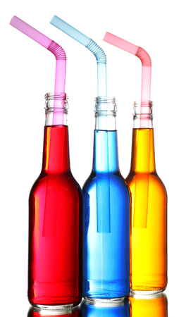Colorful alcoholic beverages in glass bottles isolated on whiteの写真素材