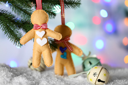 Christmas handmade decorations hanging on Christmas tree on blurred background