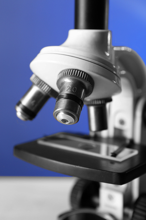 Microscope on table, on color background, close-upの写真素材