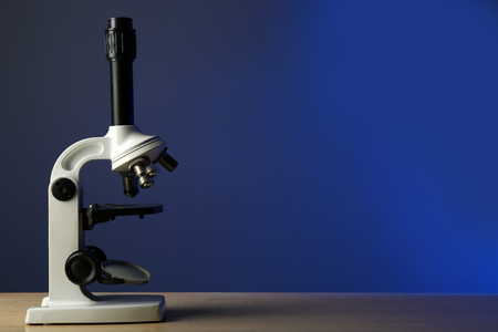 Microscope on table, on color backgroundの写真素材