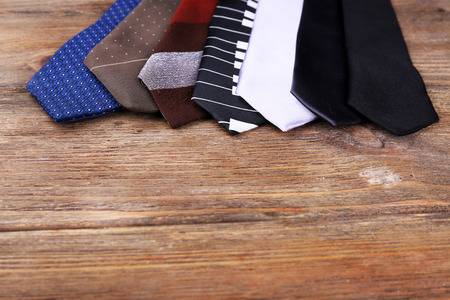 Different Ties on wooden planks backgroundの写真素材