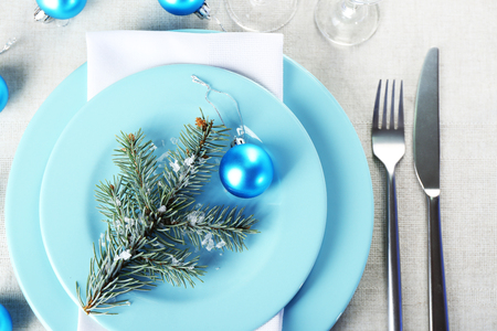 Stylish blue and white Christmas table setting on grey tablecloth backgroundの写真素材