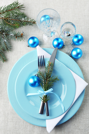 Stylish blue and white Christmas table setting on grey tablecloth backgroundの写真素材
