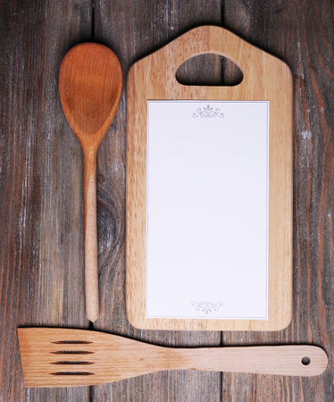 Cutting board with menu sheet of paper on rustic wooden planks backgroundの写真素材