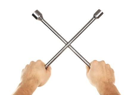 Cross wrench in male hands isolated on whiteの写真素材