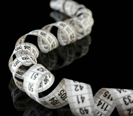 Measuring tape on black background