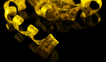 Measuring tape on black background