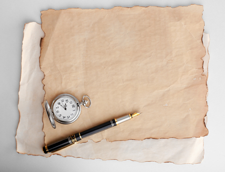 Silver pocket clock on old paper backgroundの写真素材