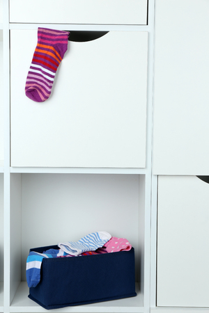 Different socks in textile box on closet backgroundの写真素材