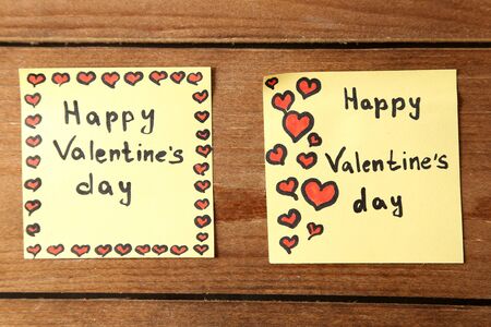 Valentines day notes on wooden background