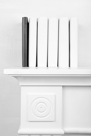 Books on shelf on wall backgroundの写真素材