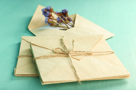 Old letters with dry flowers on wooden backgroundの写真素材