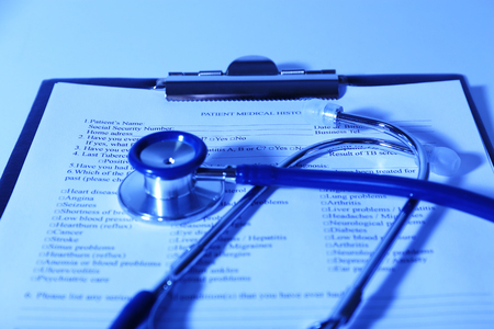 Medical history on clipboard with stethoscope on light backgroundの写真素材