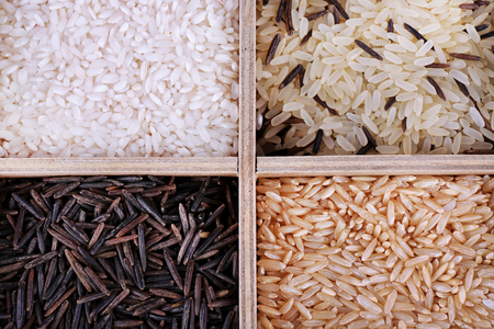 Different types of rice in wooden boxの写真素材