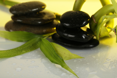 Spa stones with bamboo on light backgroundの写真素材
