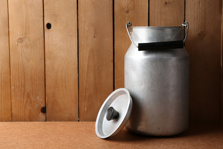 Retro can for milk on wooden backgroundの写真素材