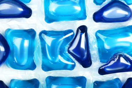 Gel capsules with laundry detergent close up
