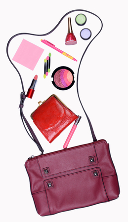 Ladies handbag and things with accessories of it isolated on whiteの写真素材