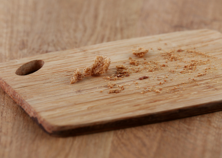 Bread crumbs on cutting board on wooden backgroundの写真素材