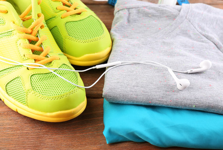 Sport shoes and clothes on wooden backgroundの写真素材