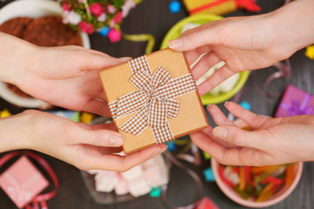 Female hands holding gift close-upの写真素材
