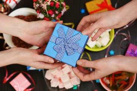 Female hands holding gift close-upの写真素材