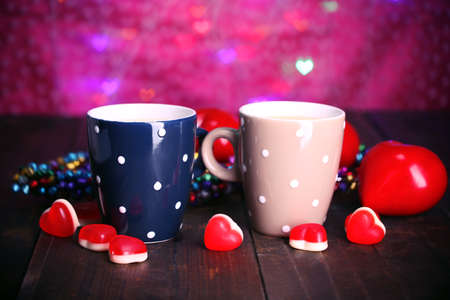 Two cups on table on lights background の写真素材