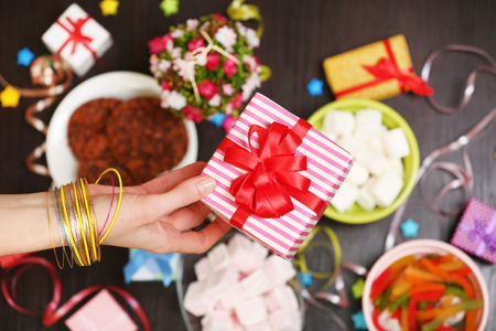 Female hands holding gift close-upの写真素材