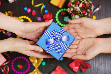 Female hands holding gift close-upの写真素材