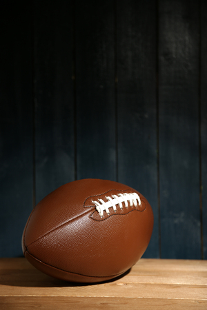 American football on wooden table, close upの写真素材
