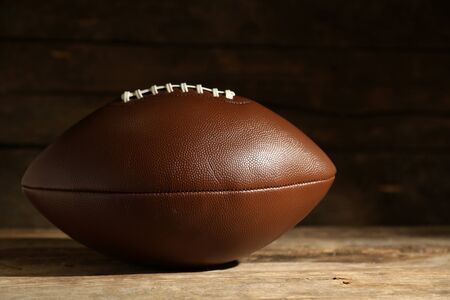 American football on wooden table, close upの写真素材