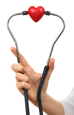 Stethoscope with heart in doctor hands, isolated on whiteの写真素材