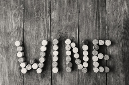 Wine corks on wooden background in shades of grey
