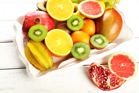 Assortment of fruits on wooden tableの写真素材