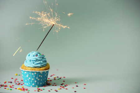 Cupcake with sparkler on grey backgroundの写真素材