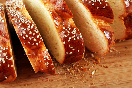 Sliced fresh bun on wooden background