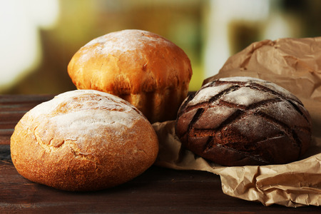 Fresh breads on table on bright background