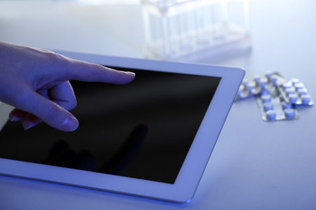 Doctor hand touching modern digital tablet, close up