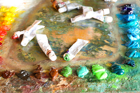 Acrylic paint with paint tubes on wooden palette