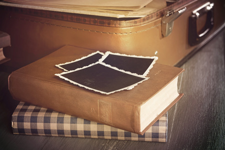 Vintage suitcase open with books on wooden backgroundの写真素材