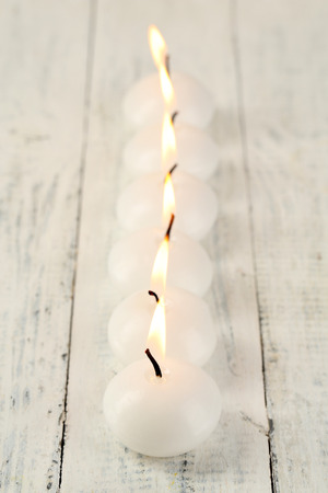 Burning candles on wooden table close-upの写真素材