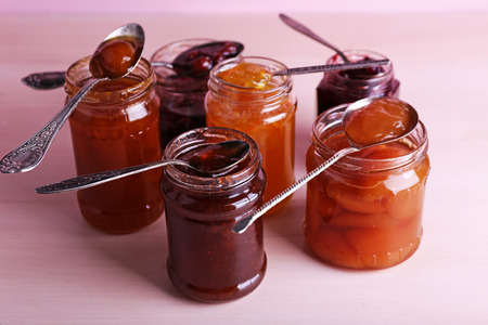 Jars of tasty jam on wooden backgroundの写真素材
