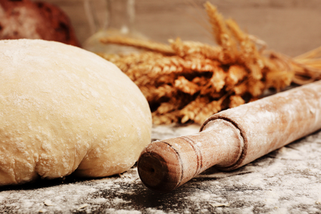 Making bread on table on wooden backgroundの写真素材