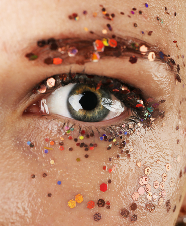 Female eye with fancy glitter makeup, macro viewの写真素材