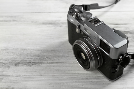 Old retro camera on wooden background