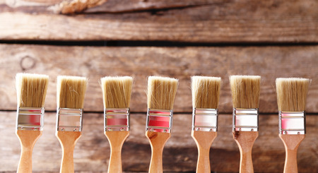 Paint brushes on old wooden backgroundの写真素材